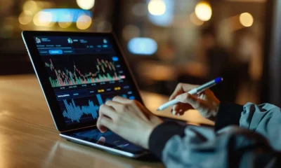 person analyzing stocks on tablet