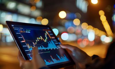 person trading stocks on tablet